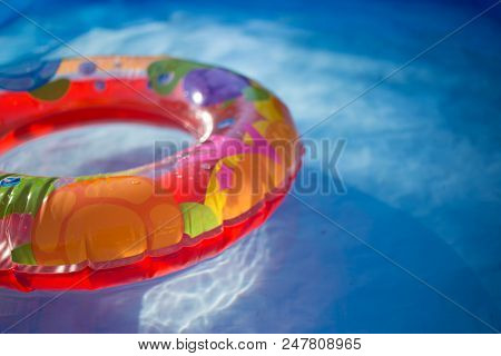 Colorful Ring Floating In A Refreshing Blue Swimming Pool