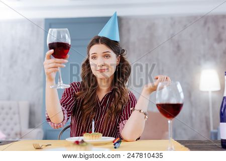 Funny Face. Beautiful Dark-haired Woman Making A Little Bit Funny Face While Attending Birthday Part