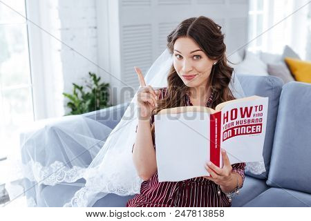 Nice Idea. Dark-haired Appealing Bride Having Nice Creative Idea While Planning Her Future Wedding