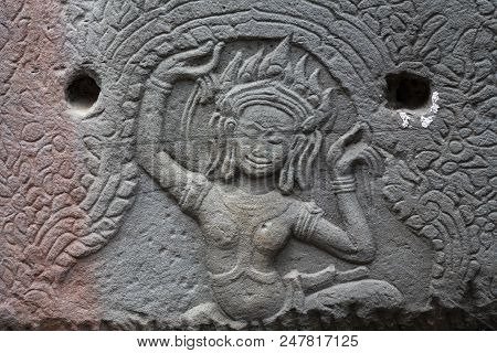 Ancient Temple Stone Carved Bas-relief In Angkor Wat. Dancing Apsara Woman Bas-relief Closeup. Angko