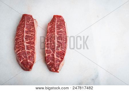 Raw Fresh Meat Top Blade Steaks On Light Background. Top View With Copy Space.