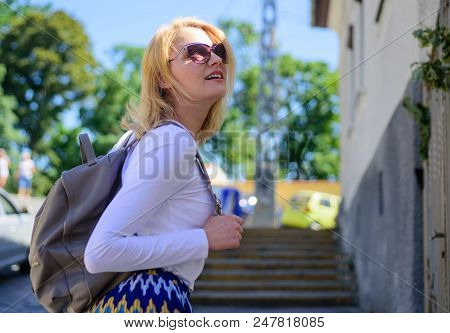 Urious Tourist. Trendy Girl Walking. Woman Carrying Backpack While Standing Outdoors. Girl With Styl