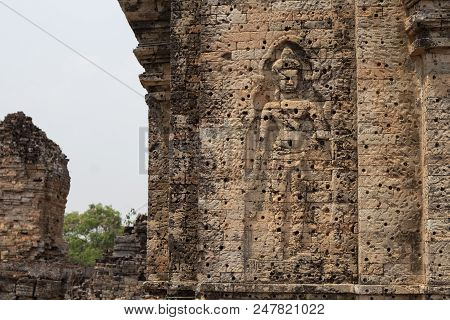 Ancient Temple In Angkor Wat Complex. Buddhist Temple Pre Rup With Stone Carving Bas-relief Human Fi