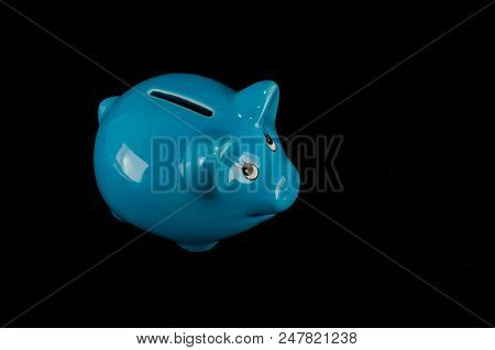 Blue Piggy Bank Or Money Box Isolated On A Black Studio Background