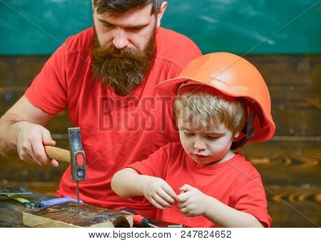 Father, Parent With Beard Teaching Little Son To Use Hobnails And Hammer. Boy, Child Busy In Protect