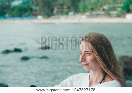 Portrait Of A Woman In White Clothes On The Beach Background