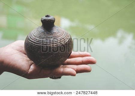 Old Thai Antique Clay Pot Earth Ware On Palm Of Woman