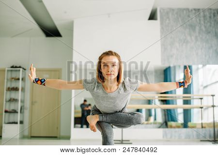 Woman Doing Balancing Exercises During A Yoga Workout Adopting A Hand To Big Toe Standing Balance Po