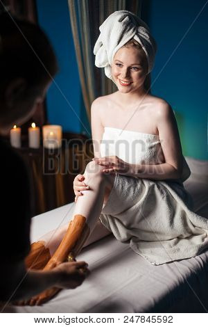 Beautiful Caucasian Woman Getting Body Clay Mask After Massage Treatment With Happy Mood On Vacation