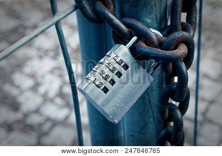 Padlock On A Construction Site With A Rusty Chain To Illustrate Encryption With A Numerical Code In 