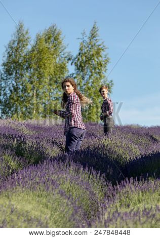 Ostrow, Poland - June 6, 2018:  Two Beautiful  Woman  In The Middle Of A Lavender Field In Bloom. Os