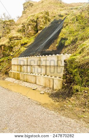 Concrete And Netting Holding Back Landslip On Walking Trail.