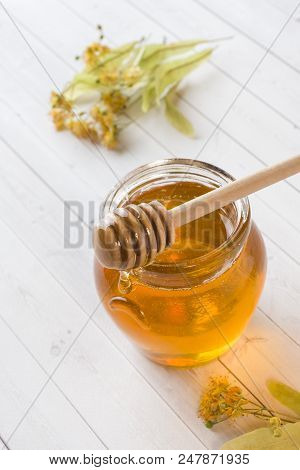 Glass Jar Of Honey, Linden Flowers On Light Background