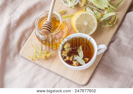 Tea With Linden, Honey And Lemon. The Tray On The Bed, The Concept Of The Treatment Of Colds