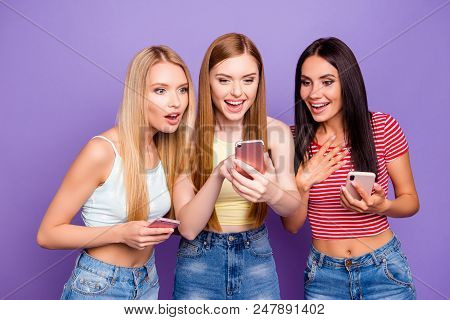 Ha-ha! Portrait Of Positive Cheerful Girl Showing Something Comic On Smart Phone To Surprised Friend