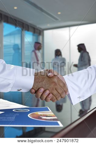 Saudi Arab Businessmen Shaking Hands, And Making Agreement Or A Deal
