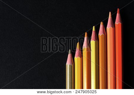 Yellow And Orange Colored Pencils, Black Background, Free Copy Space, Selective Focus