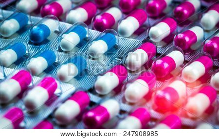 Closeup Pink-white And Blue-white Antibiotics Capsule Pills In Blister Pack. Antimicrobial Drug Resi