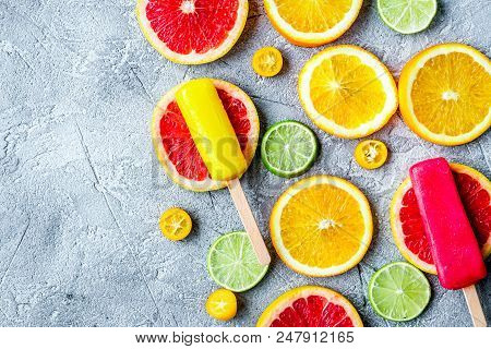 Fresh Citrus Slices With Fruit Popsicles On Stone Table Background Top View Mock Up