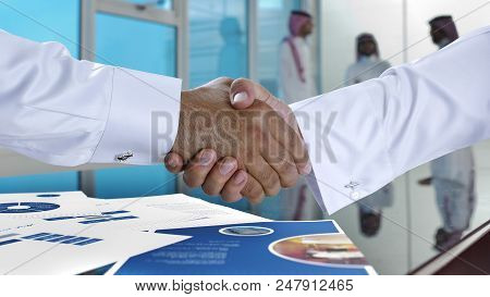 Saudi Arab Businessmen Shaking Hands, And Making Agreement Or A Deal