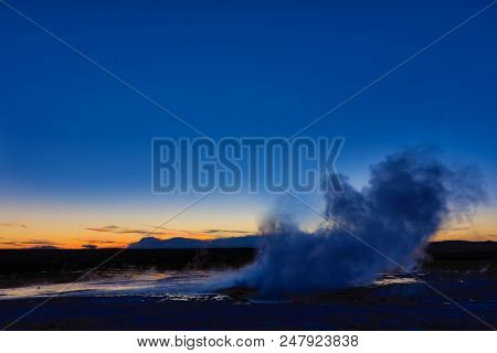 Clepsydra geyser in Yellowstone National Park in Wyoming erupts almost continuously and is beautiful at sunset.  It is located in the Lower geyser basin.