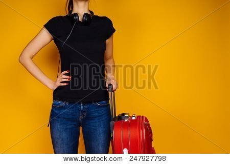 Slender Young Girl In A Black T-shirt Goes On A Trip With A Big Red Suitcase, Leave