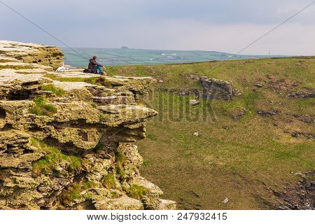 Tintagel, United Kingdom - May 02, 2014: View Of Tintagel Island With Tourist On The Rock On The Cor