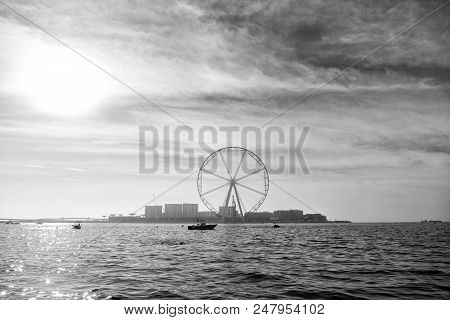 Ferris Wheel In Dubai, United Arab Emirates, From Blue Sea. Seascape Skyline, Urban Landscape. Obser