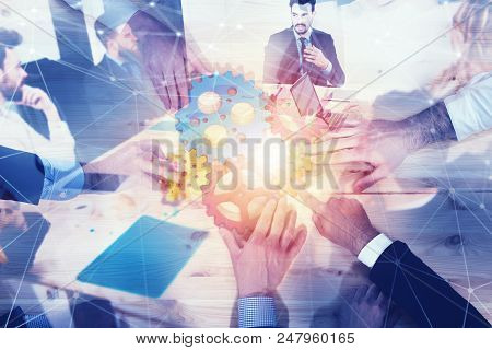 Teamwork Of Businesspeople Work Together And Combine Pieces Of Gears. Partnership And Integration Co