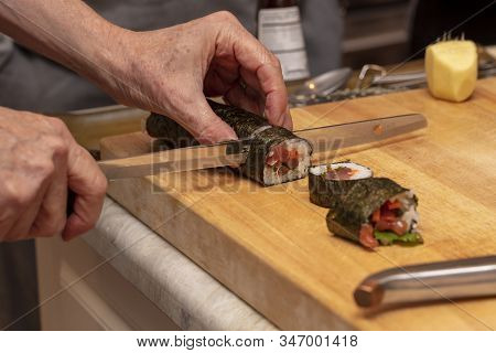 Sushi Roll Being Sliced In A Demonstaration Class