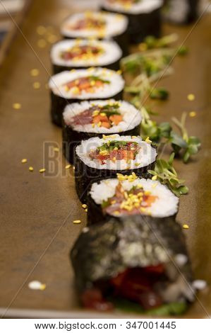 Sushi Roll Being Sliced In A Demonstaration Class