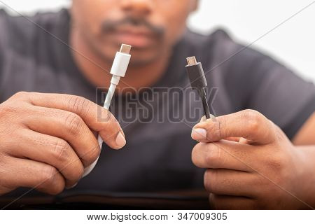 Selective Focus On Hands Holding Micro Usb And Usb Type C Ports Concepts Showing Of Confusion On Cha