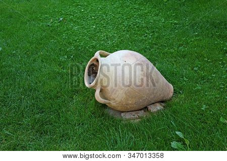 Ancient Style Armenian Wine Jar Isolated On Vibrant Green Lawn