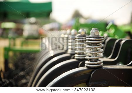 Spring Shock Absorbers Cultivator. A Fragment Of Agricultural Machinery For Loosening Plowed Fields.