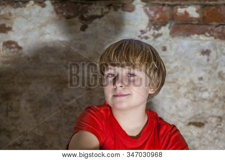Boy With Light Brown Hair And Brown Eyes Lookes Friendly, Happy And Smiles, Full Of Positice Self Co