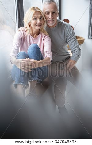 Beautiful Adult Couple By The Window At Home Stock Photo