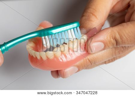 Clean Dental Prothesis With Toothbrush