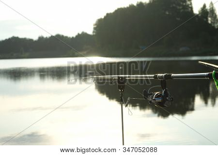 Carp Fishing On Beautiful Blue Lake With Carp Rods And Rod Pods In The Summer Morning. Fishing From 