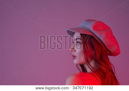 Close-up. Profile. Girl In Profile Biret Looks Into The Distance Color Filter Pink Background. Beaut
