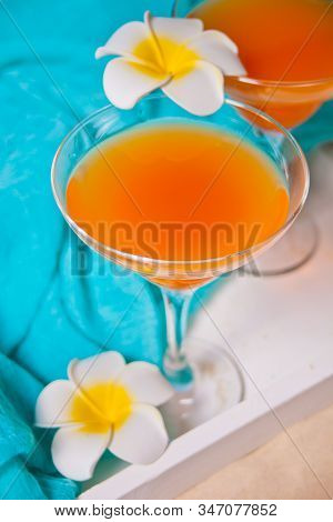 Glasses Of Tropical Exotic Multifruit Juice Cocktail Drink On The White Tray With Plumeria Frangipan