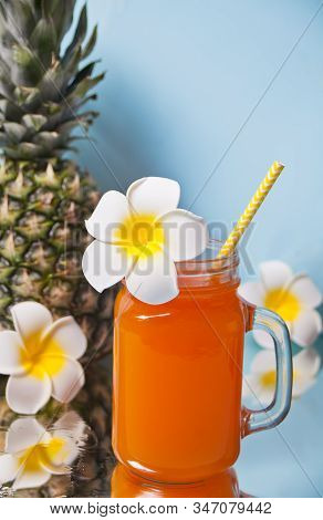 Glass Of Tropical Exotic Multifruit Pineapple Juice Cocktail Drink With Plumeria Frangipani Flowers 