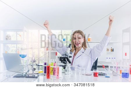 Pretty Scientist Work Reserching And Cheerfully In Chemical Laboratory, Science And Healthy Or Medic