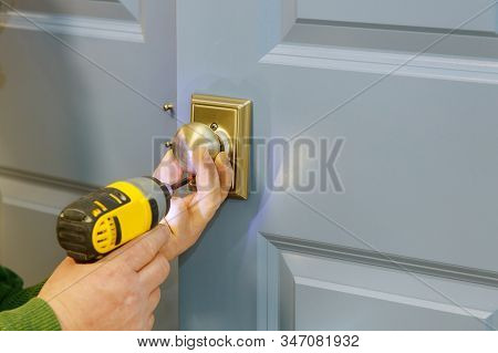Carpenter Hands With Doorlock During Lock Process Installation