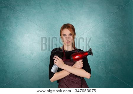 Smiling Girl Hairdresser Holds Fan And Spray In Hands