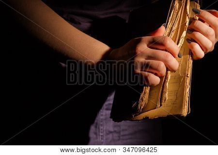 Woman Opening Vintage Worn Book. Closeup Female Hands Holding Holy Bible.