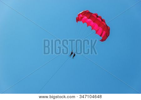 Tourists Have Fun, Parachuting Behind A Boat, Parasailing