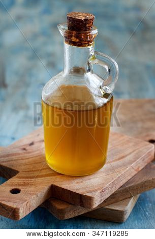 Olive Oil In A Bottle On A Blue Wooden Background