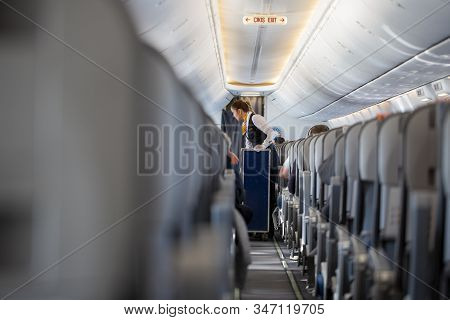 Antalya / Turkey - January 24,2020: Stewardess From Airline Sunexpress, Goes With A Service Wagon Th