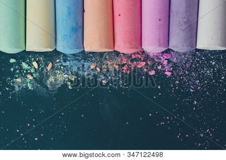 Crumbs And Chunks Of Multicolored Chalk, Pastels On The School Board. Yellow, Pink, Red, Green, Gray