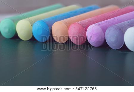 Chunks Of Multicolored Chalk, Pastels On The School Board. Yellow, Pink, Red, Green, Gray, Light Gre